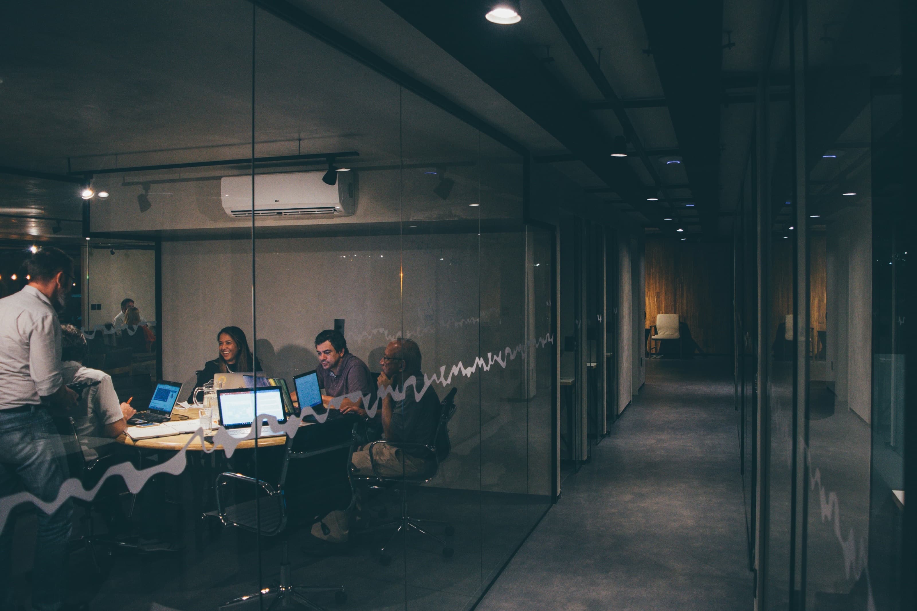 People collaborating in an office — shared knowledge, every team member.